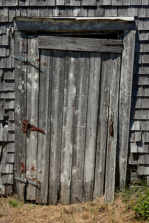"old door", "wooden door", "rusty Hinge", "bleached wood", "crooked door", "old building",  ,